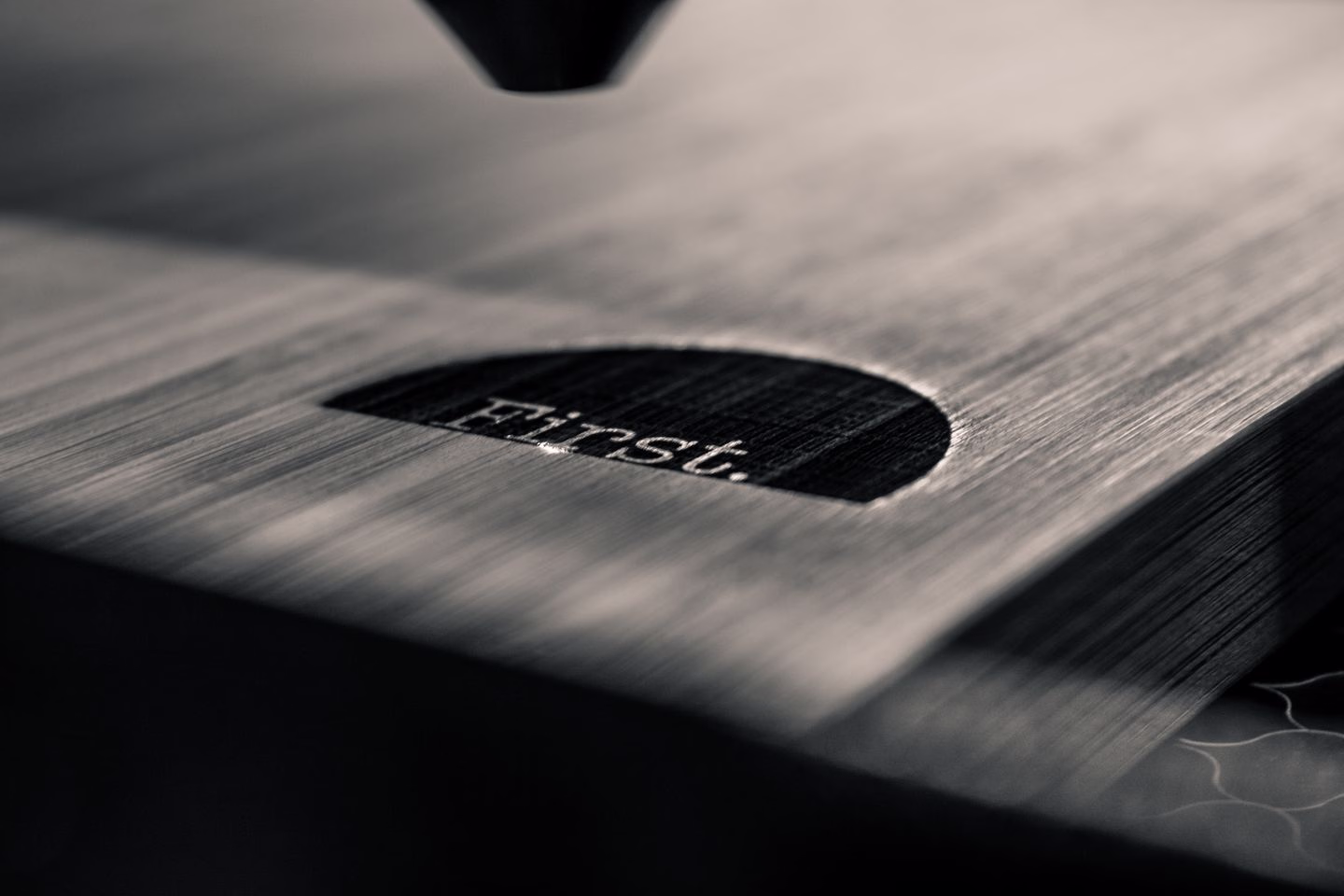 Laser engraving a design into a wooden surface — Source Select.