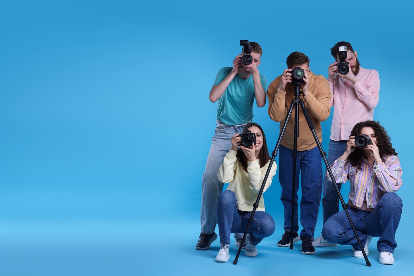 Photographers on a blue studio background — Source Select.