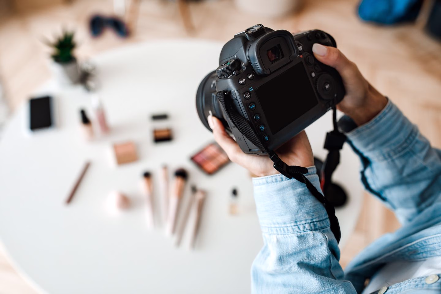 Hands photographing products with a camera — Source Select.