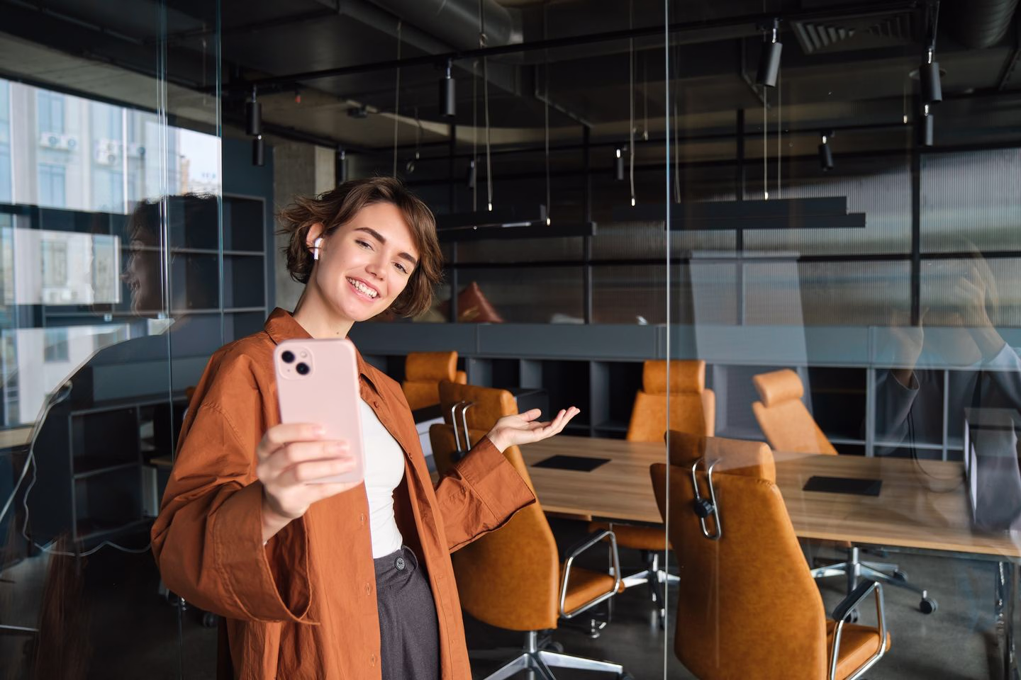Content creator using a smartphone in a workspace — Source Select.