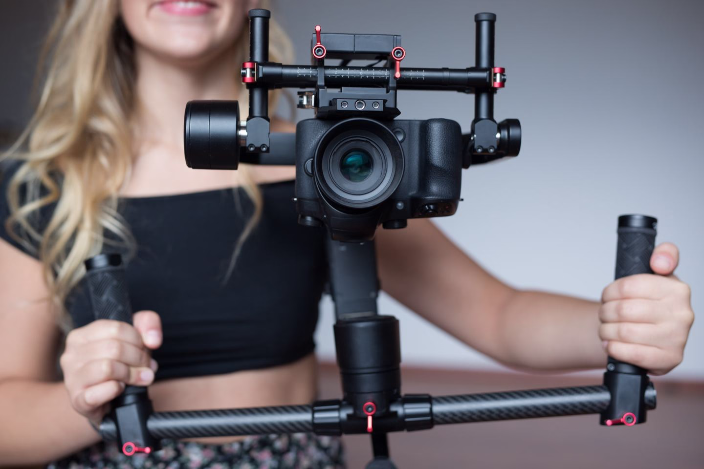 Videographer operating a professional camera rig — Source Select.