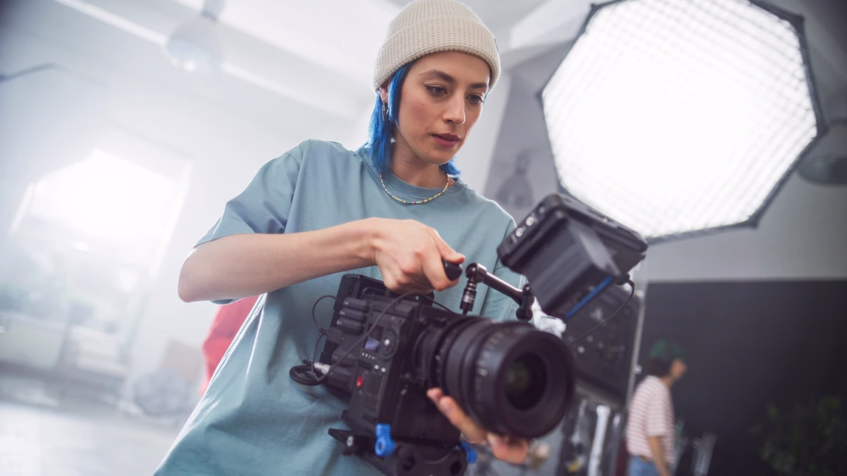 Videographer adjusting a professional camera rig — Source Select.