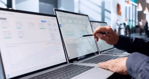 Reviewing analytics across computer screens — Source Select.
