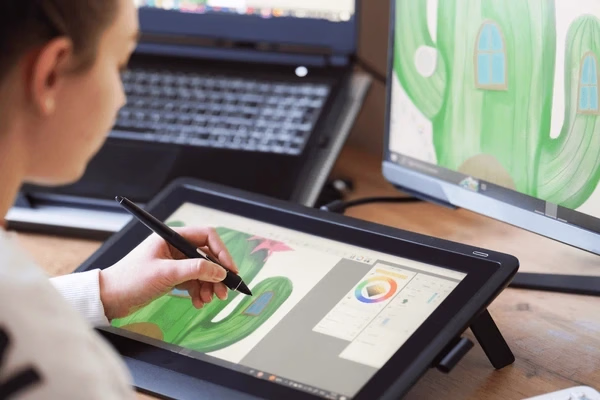 Illustrator drawing on a pen display — Source Select.