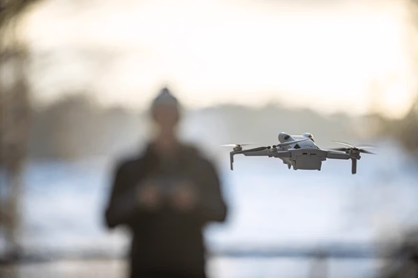 Drone flying near its operator — Source Select.